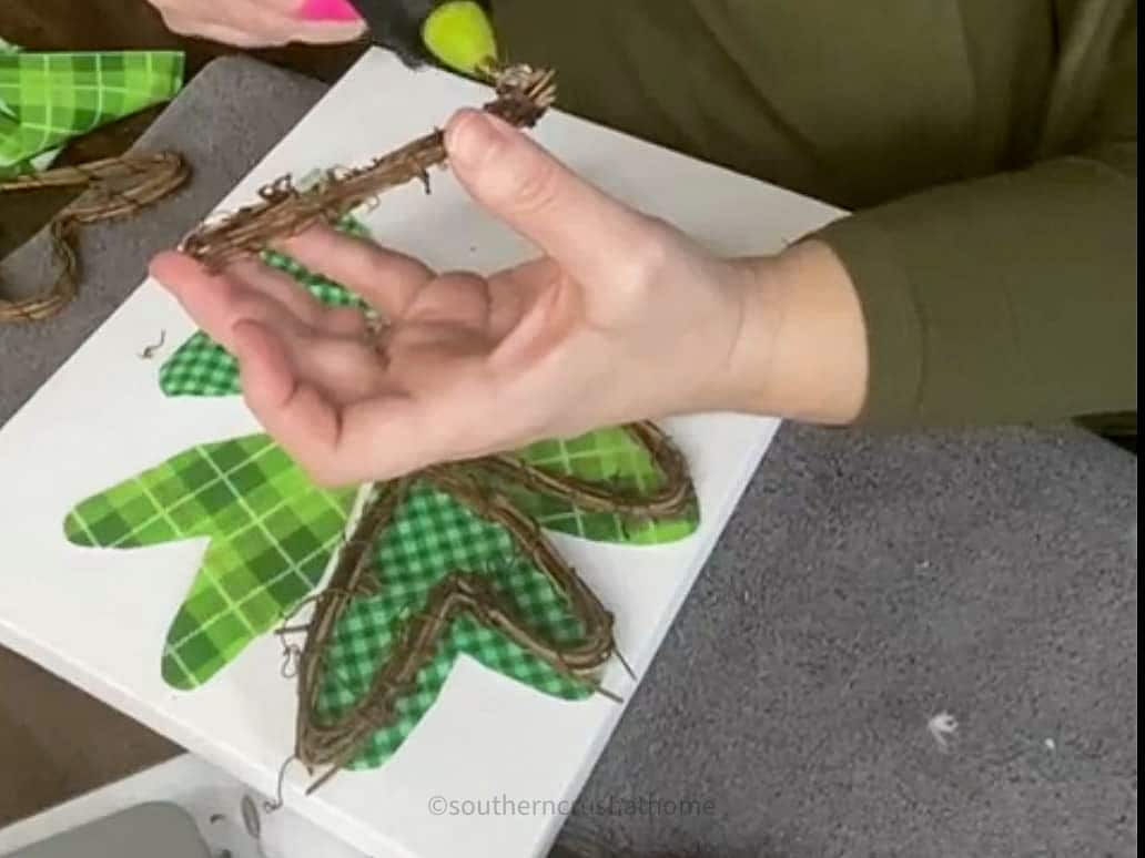 gluing grapevine hearts onto shamrock