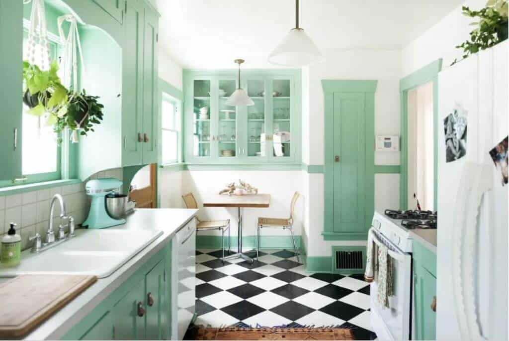 mint kitchen with black and white tiles