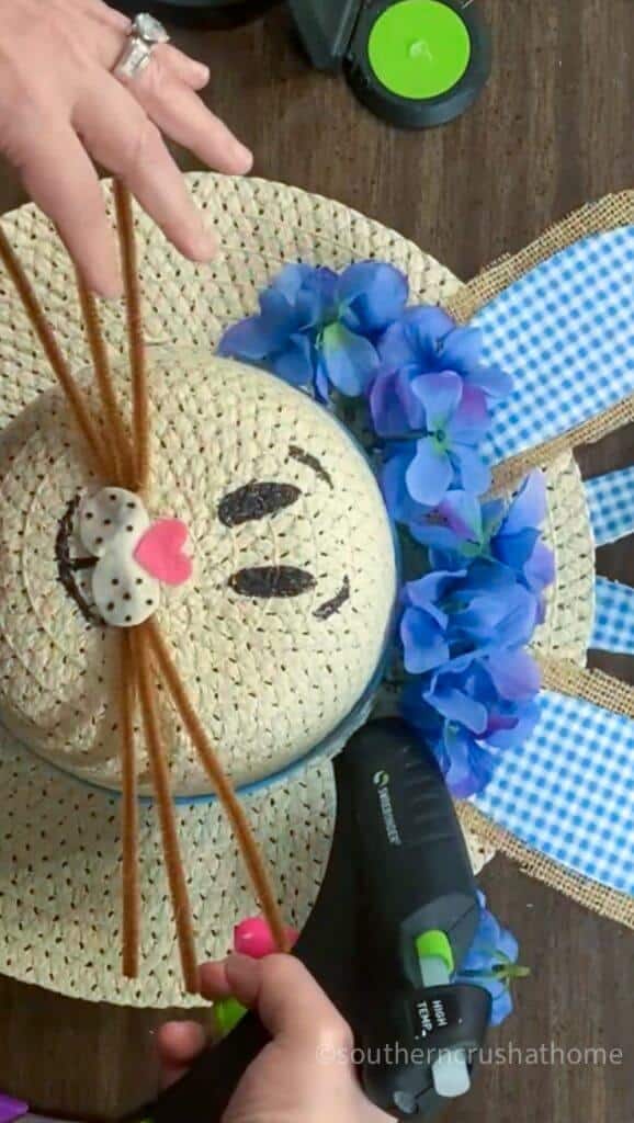 painting bunny face on sun hat