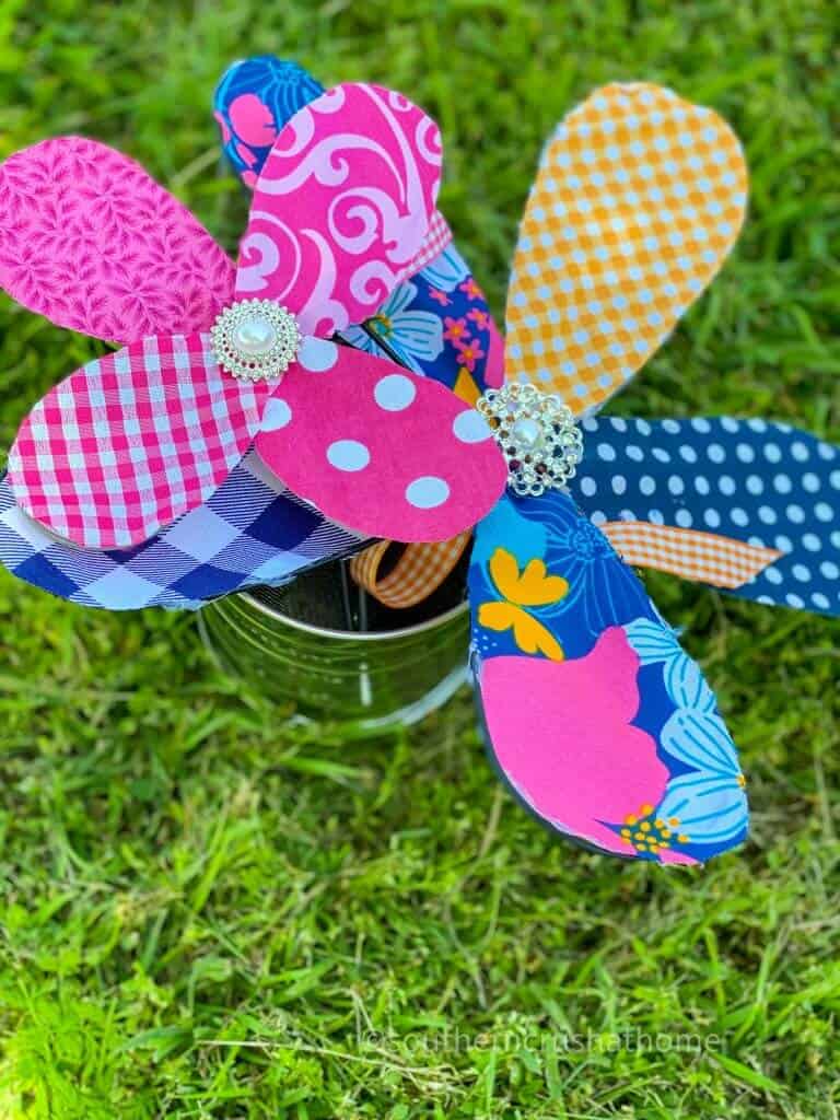 two kitchen whisk fabric flowers in yard