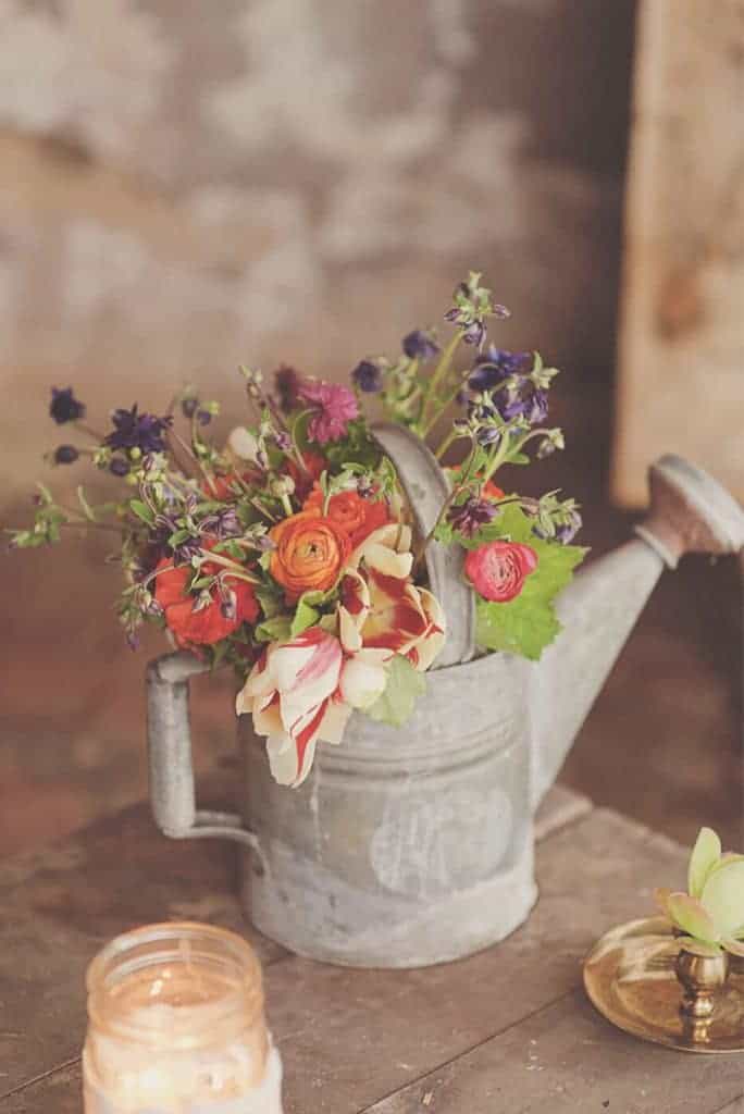 watering can with summer flowers