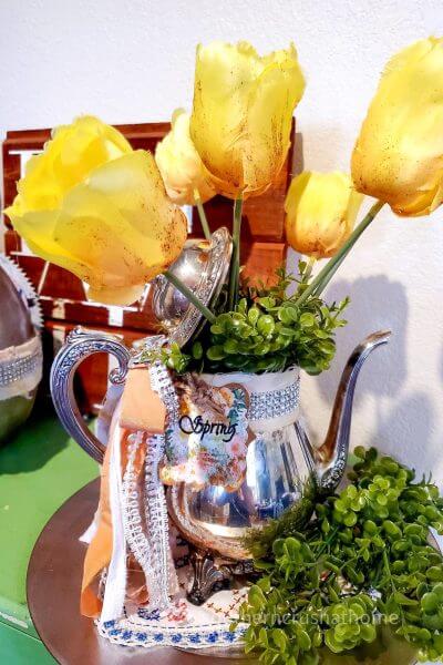 tea pot centerpiece on table with yellow roses