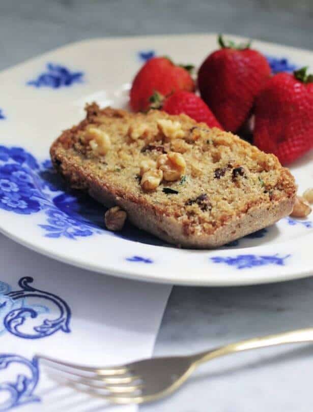 zucchini bread on blue and white plate with strawberries