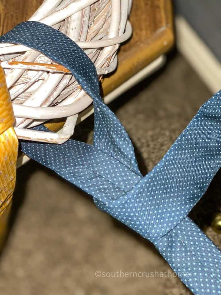 close up of necktie being wrapped around wreath