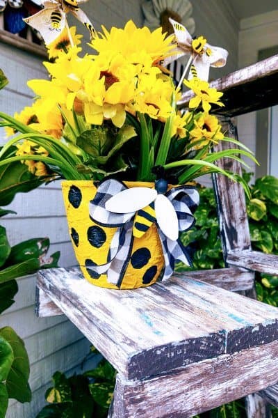 diy textured flower pot with yellow flowers on table