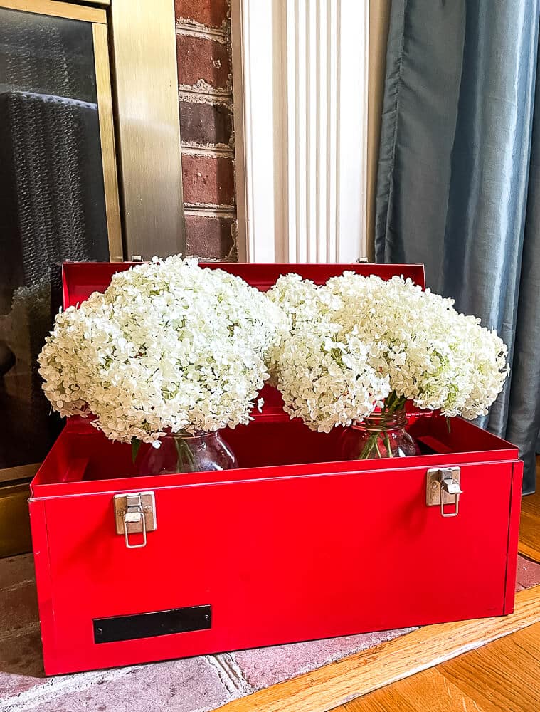 Red toolbox with hydrangeas