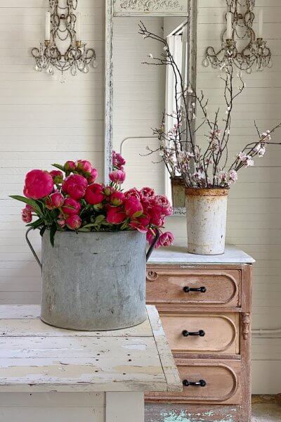 galvanized bucket on counter with flowers