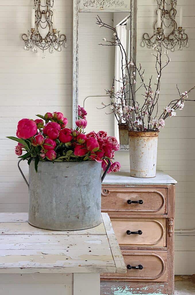 galvanized bucket on counter with flowers