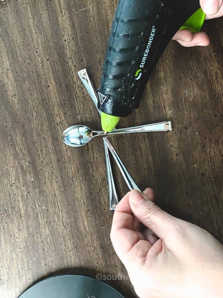 using hot glue gun to secure plastic spoon