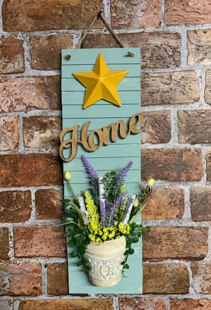 shiplap sign hanging on brick