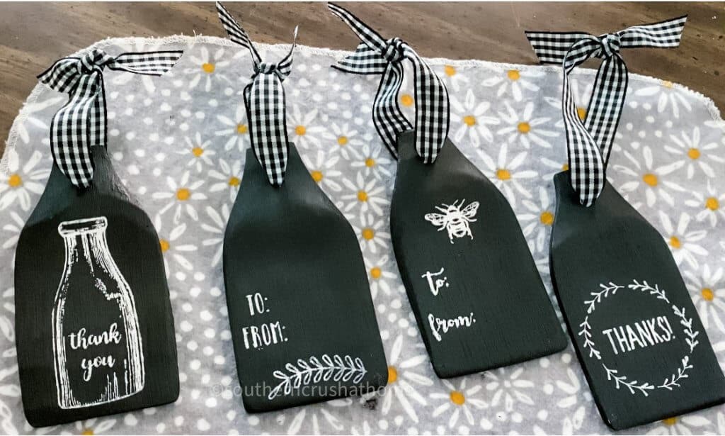 Several designs of dollar tree wooden spatula gift tags completed