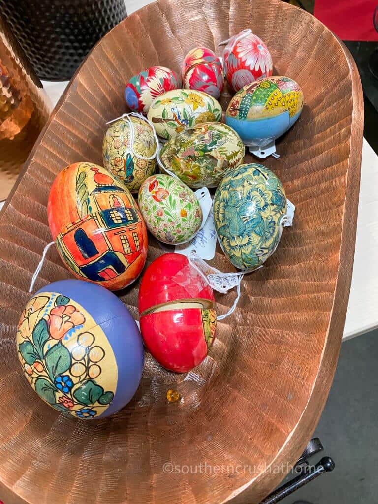 colorful wooden eggs in wooden dough bowl display