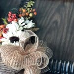 mesh ribbon attached to fall frame with fall flowers