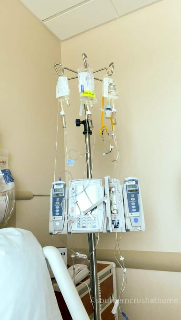 rounds of intraveneous medicines hanging from a pole