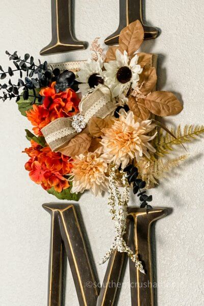 close up of fall foliage on home sign