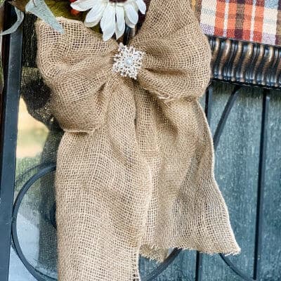 burlap bow hanging from fall sign