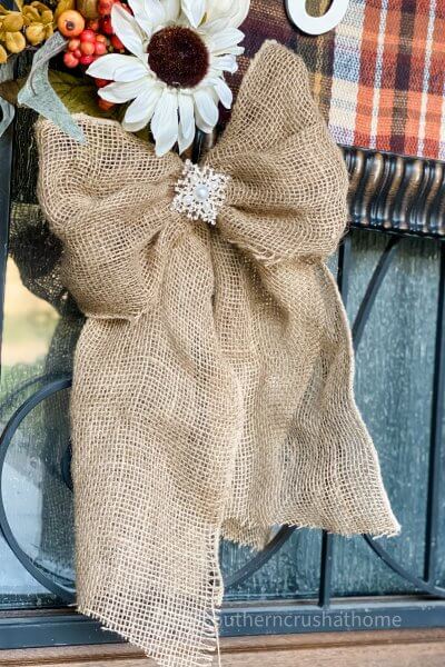 burlap bow hanging from fall sign