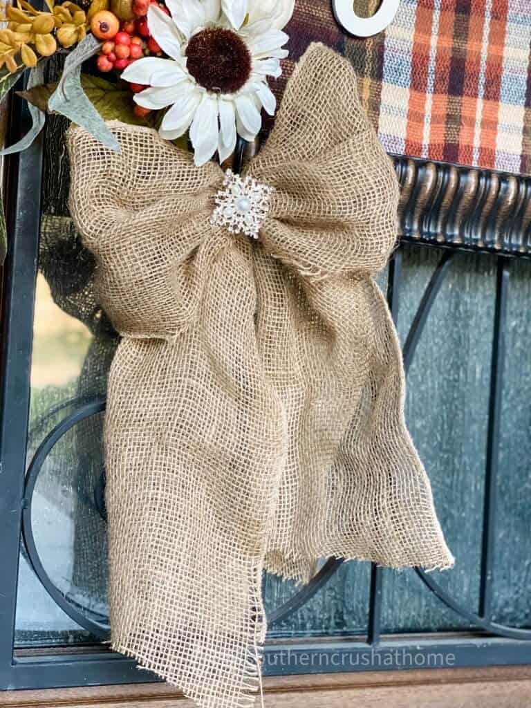 burlap bow hanging from fall sign