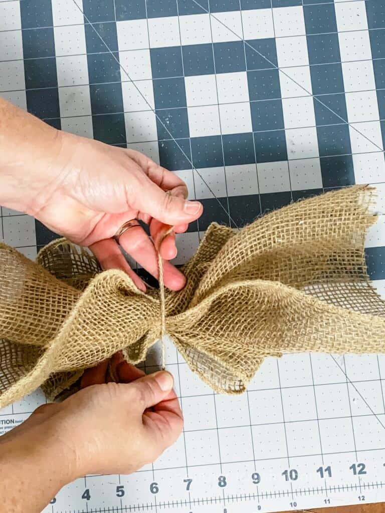 tying twine to burlap bow