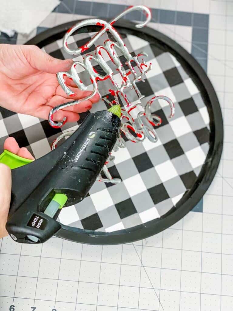 gluing the sign to the wreath