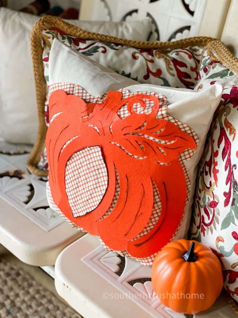 pumpkin pillow on bench