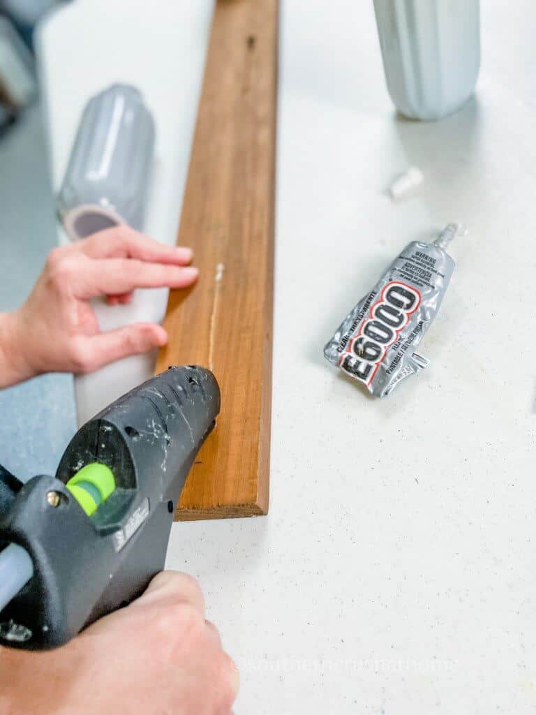 adding hot glue to wood sign