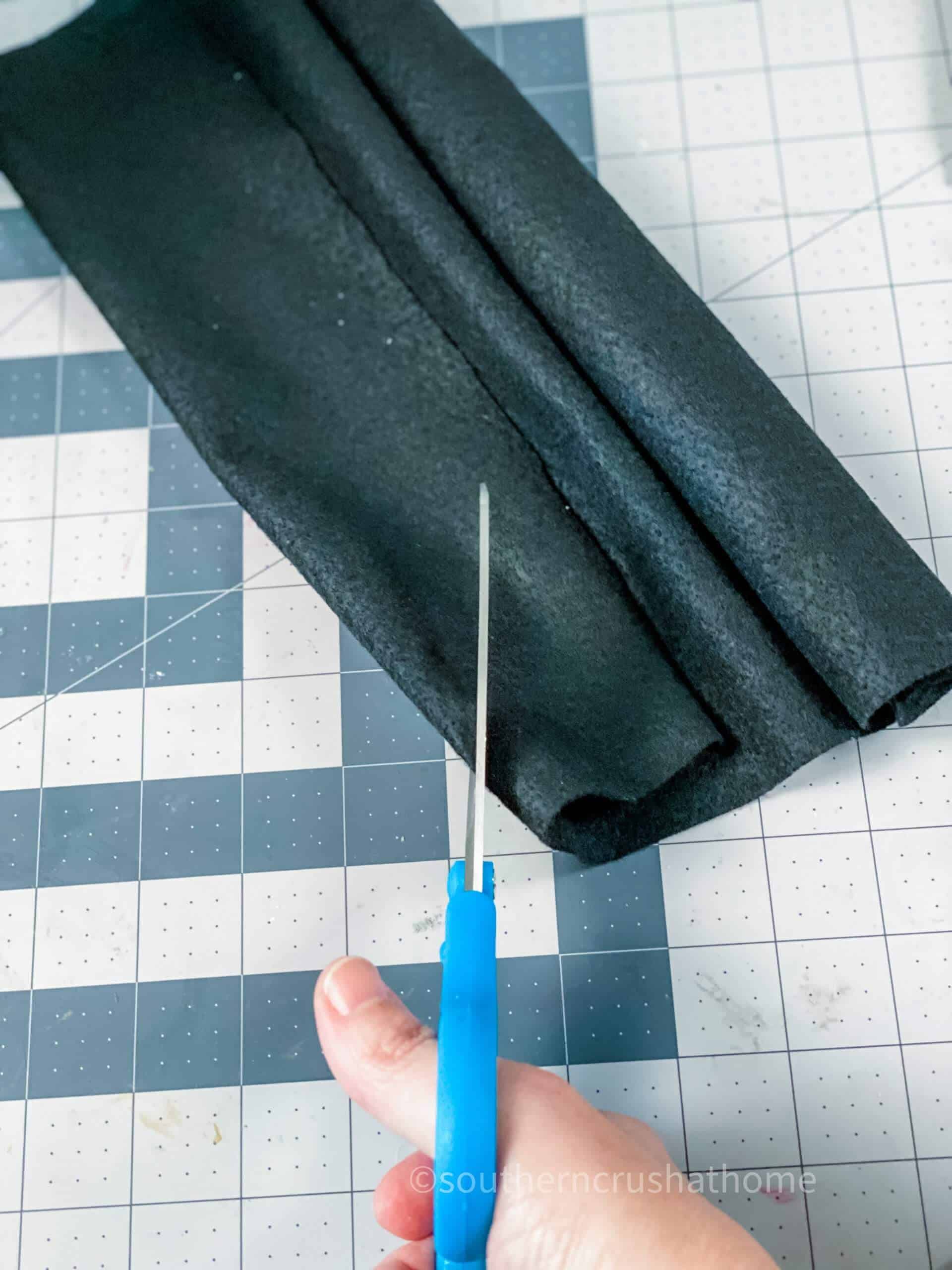 cutting black felt for ghost eyes