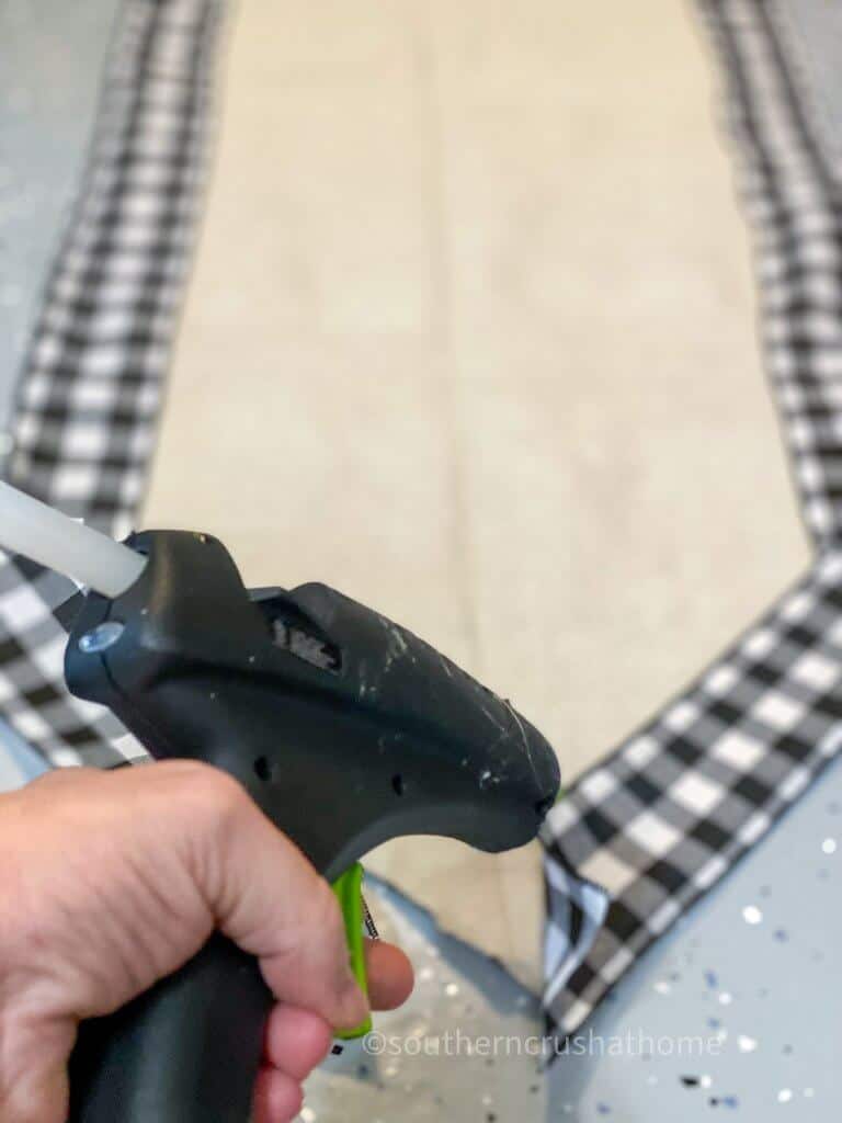 gluing buffalo check to drop cloth