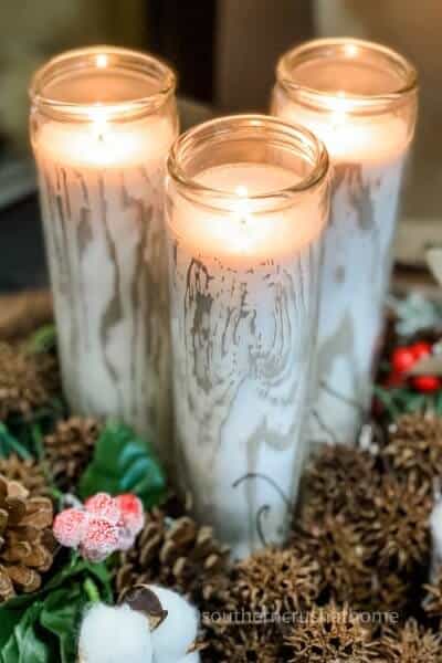 faux birch logs close up lit candles