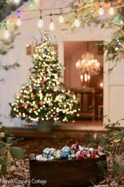christmas tree lit in the background outside