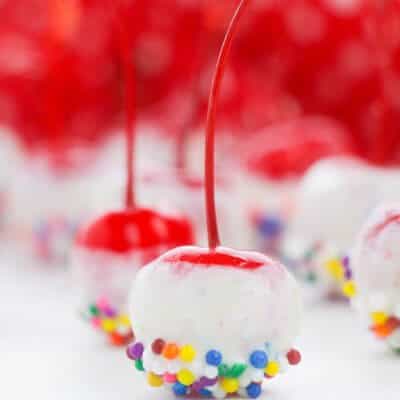 close up of cherries covered in candy