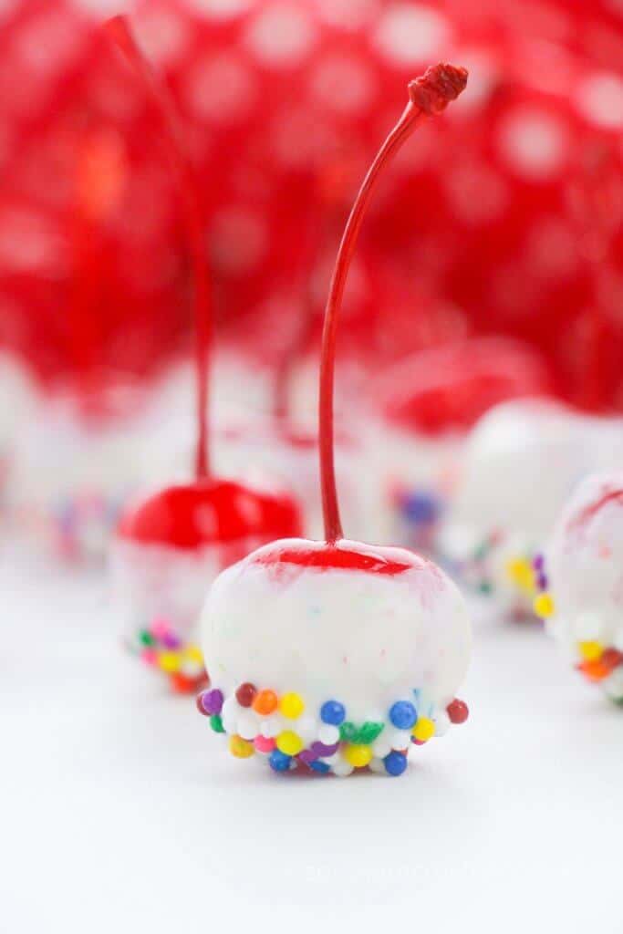 close up of cherries covered in candy