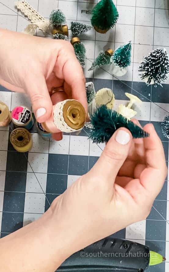 attaching bottle brush onto wooden spool