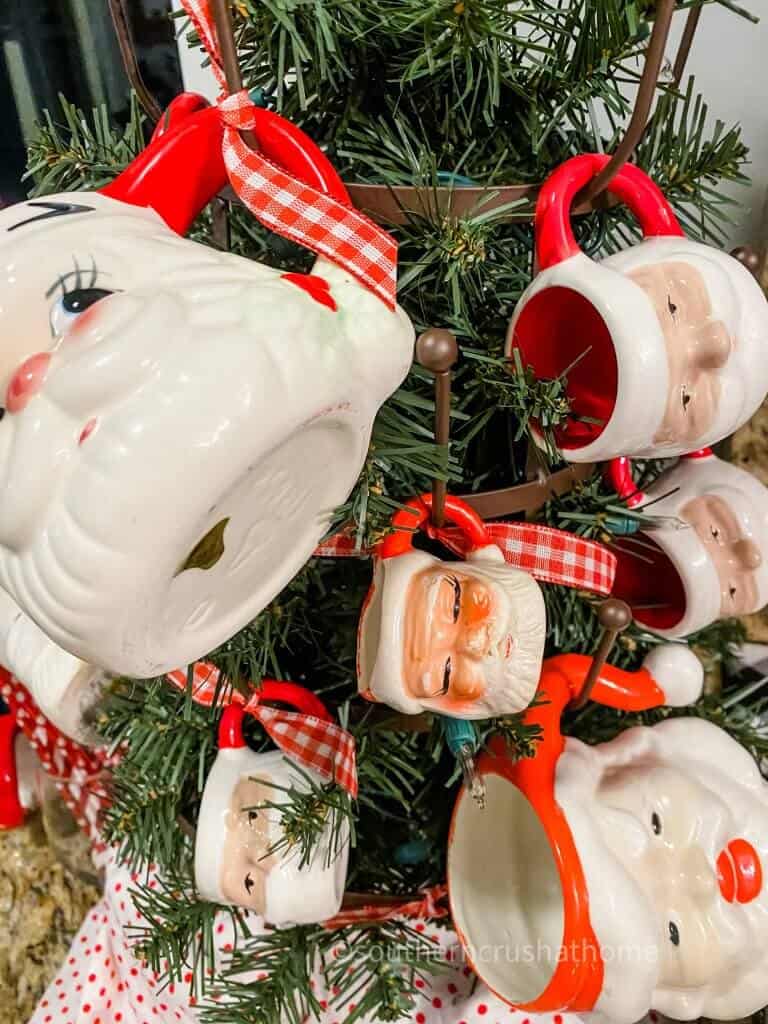 close up of santa mugs on tree