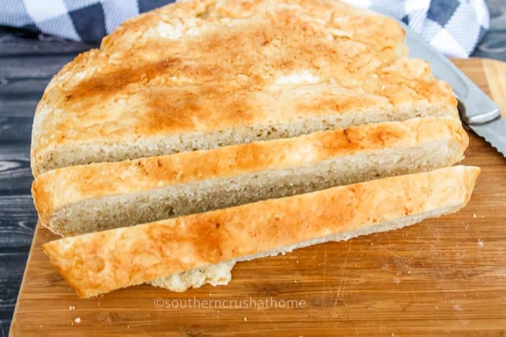 sliced homemade dutch oven bread on cutting board