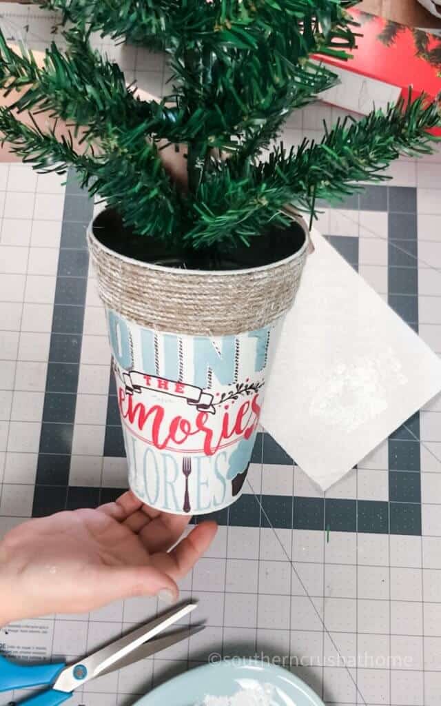 placing christmas tree in bucket