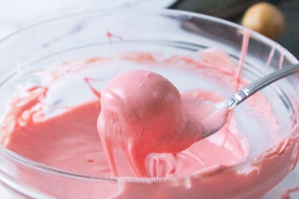 pink melted chocolate in glass bowl