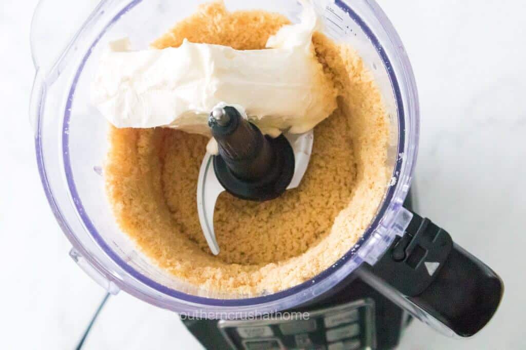 adding butter to food processor