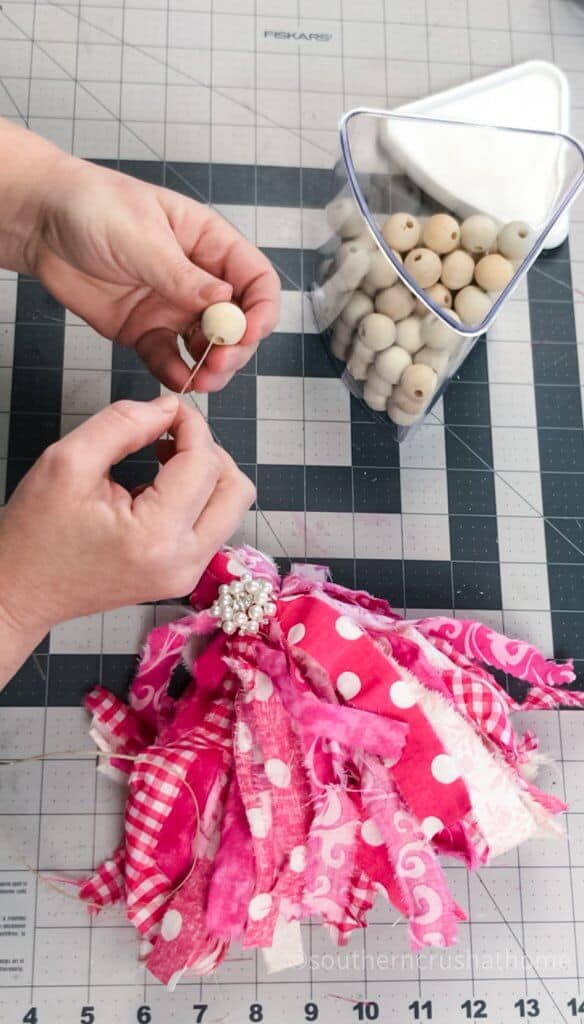 stringing wood beads to tassel