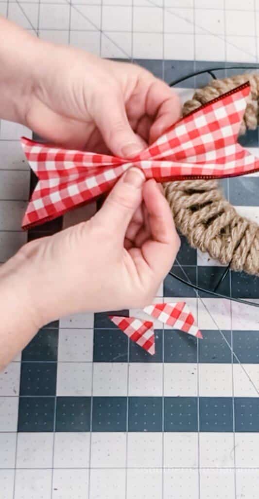 gathering corners of ribbon to attach to wreath