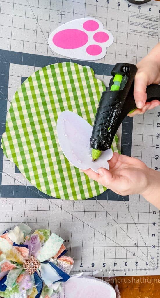 gluing white bunny feet to wreath