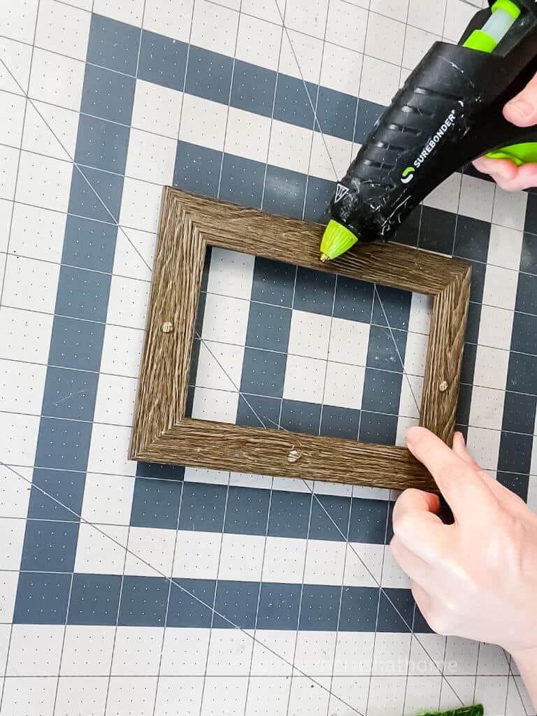 adding hot glue to frame