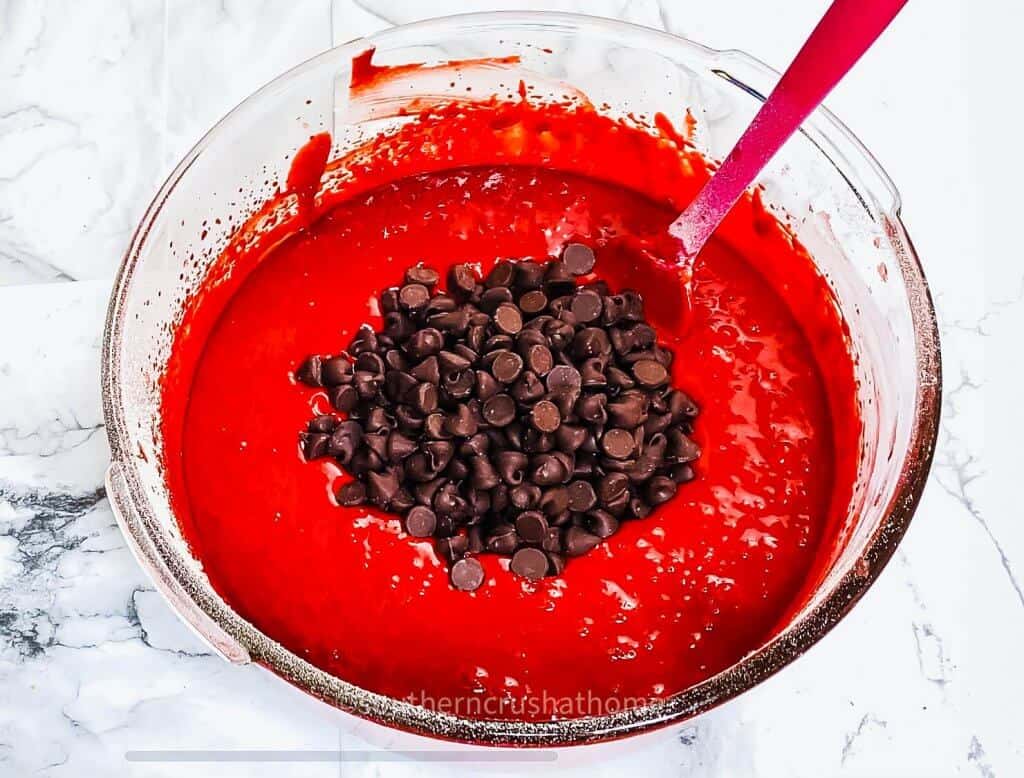 adding chocolate chips to red velvet batter