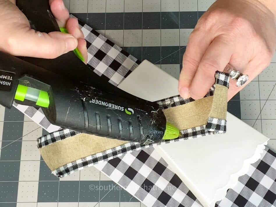 adding ribbon to popcorn buckets