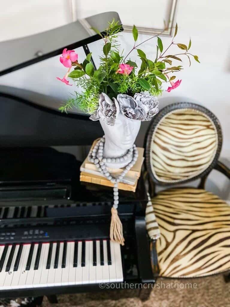 faux concrete head vase on piano