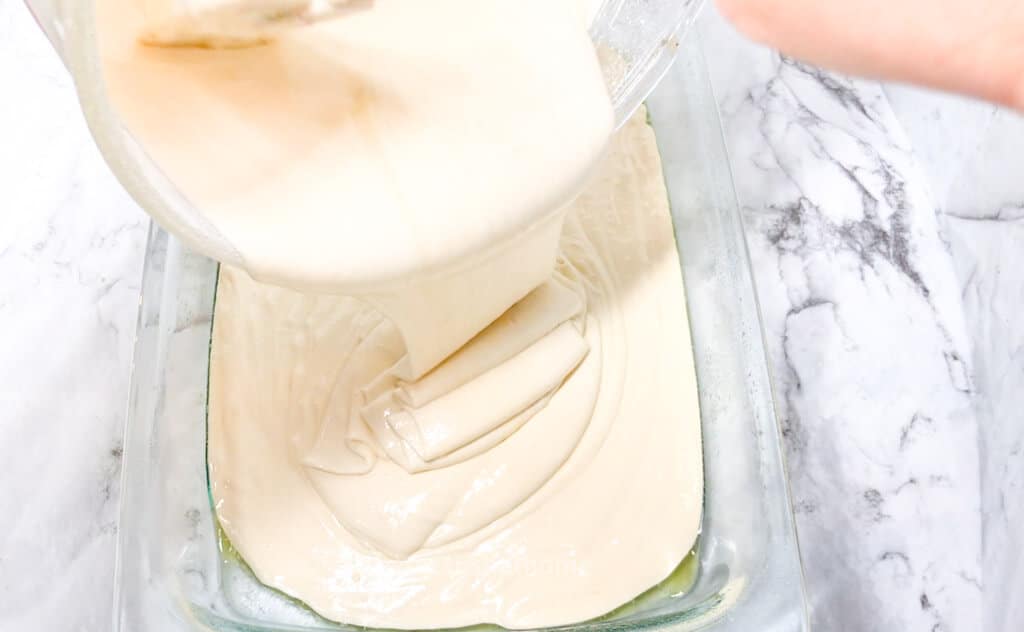 pouring white cake batter