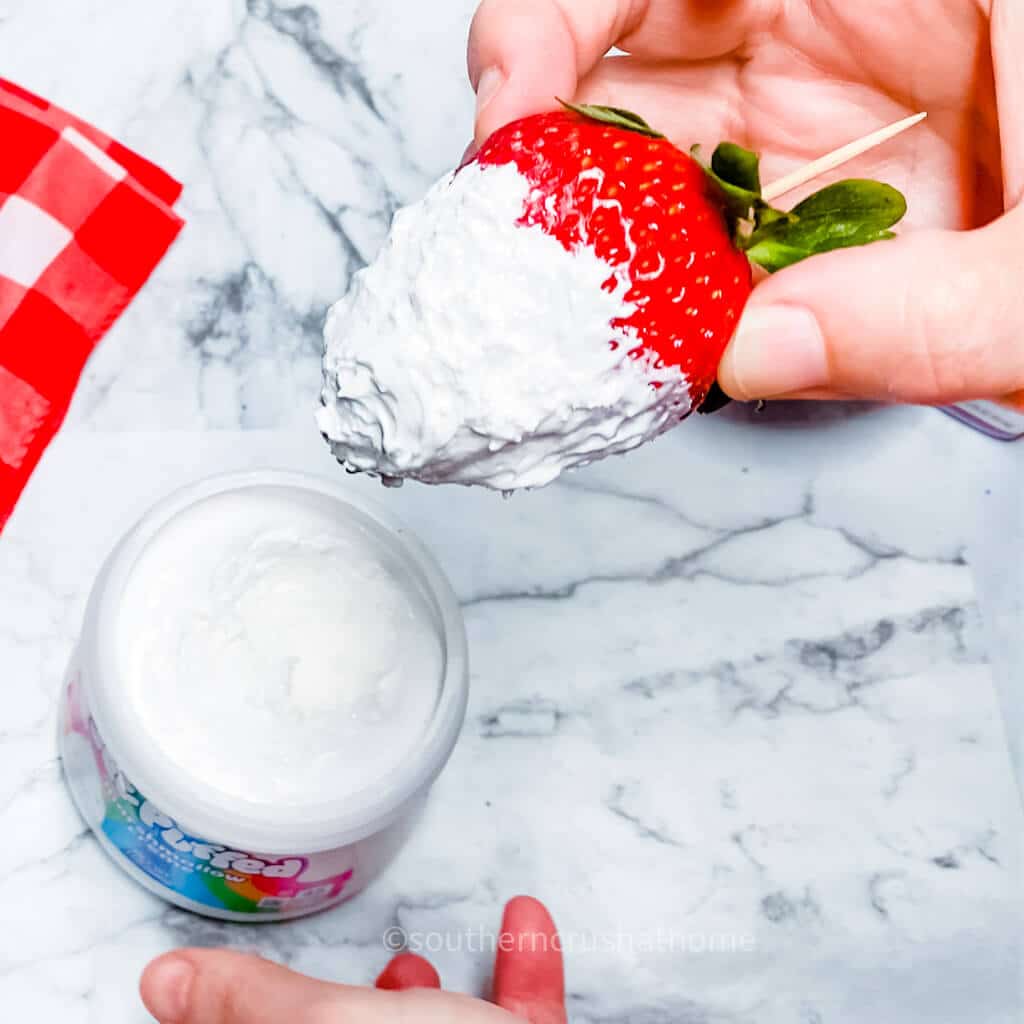 dipping strawberries in creme