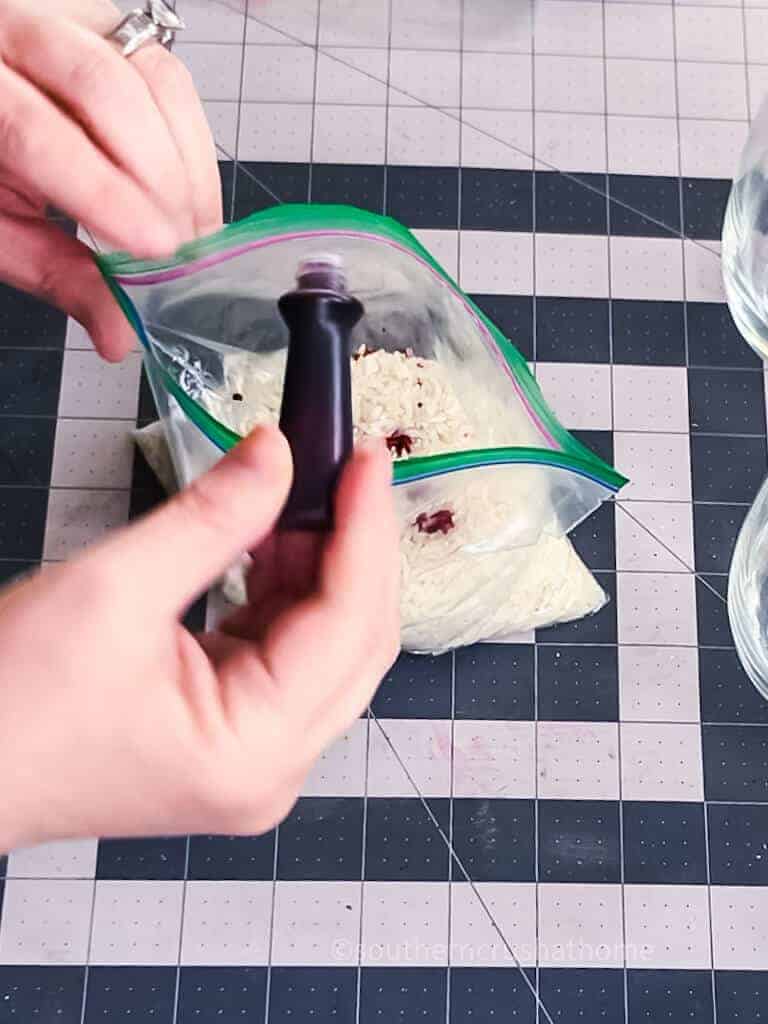 adding red food coloring to rice