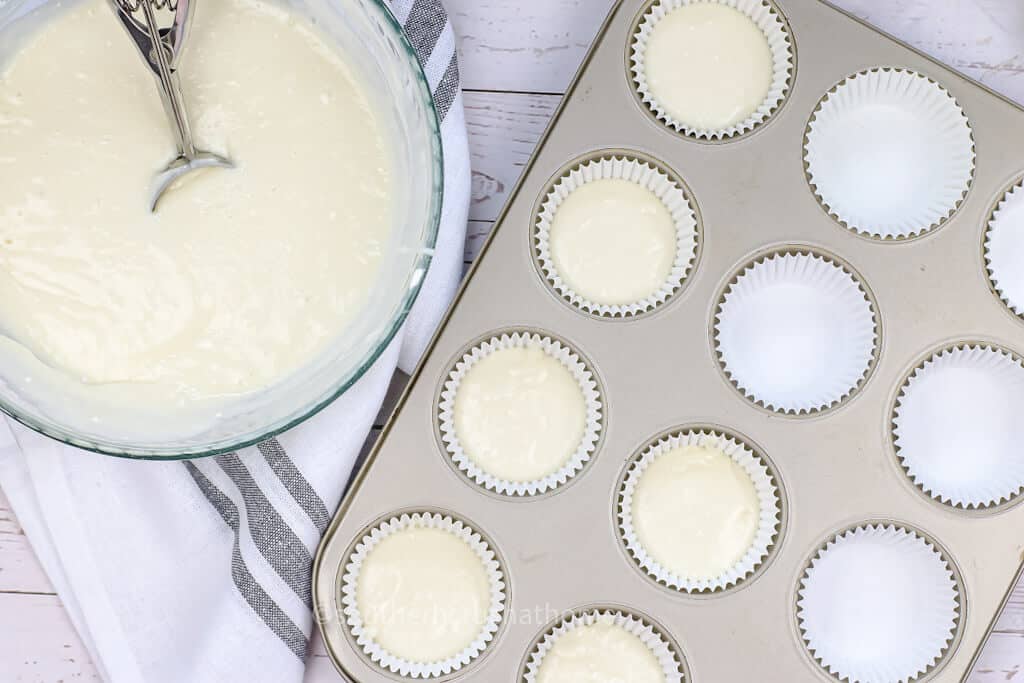 adding cupcake batter to pan