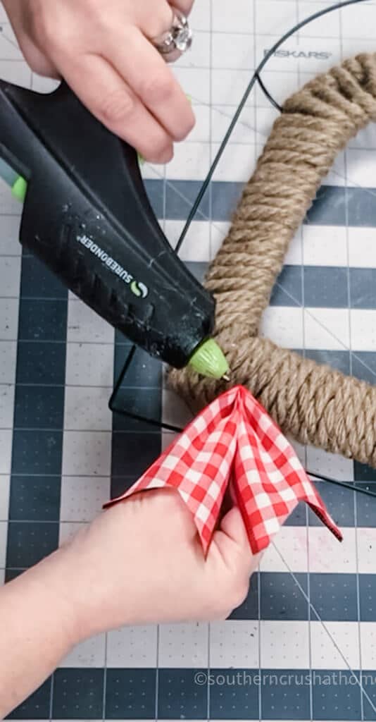 gluing ribbon to wreath